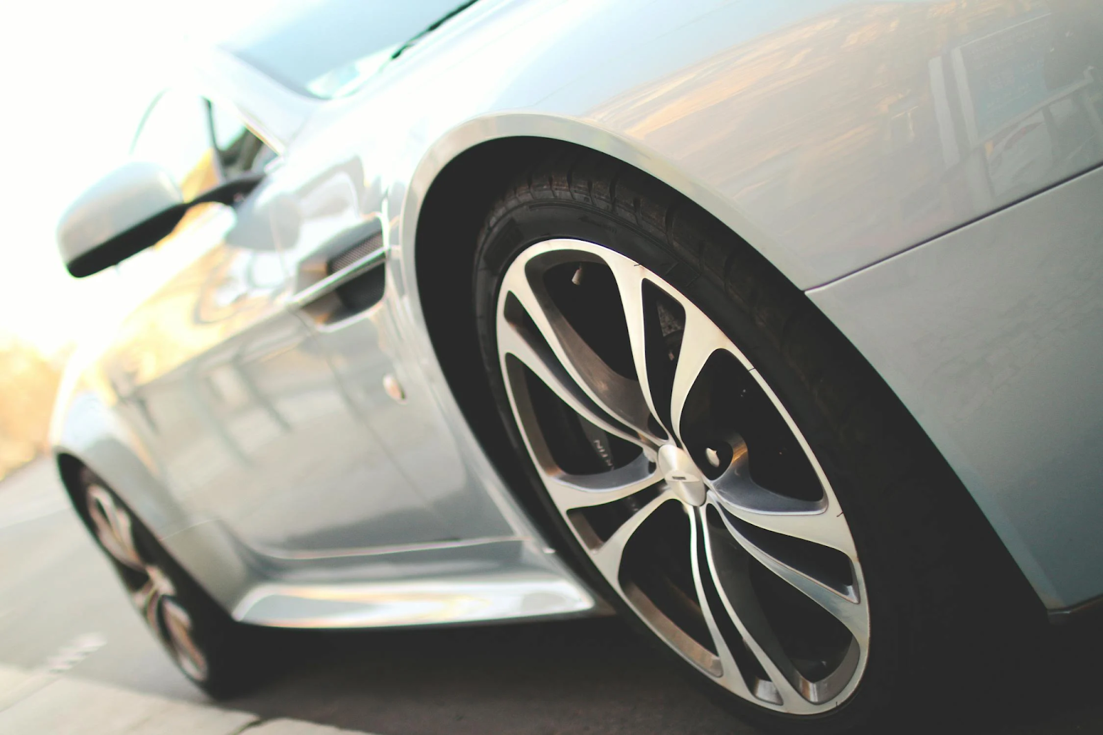 Close-up of a car's wheel and tire, showcasing the tread pattern and rim details.